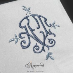 AT interlocking monogram in blue on grey background